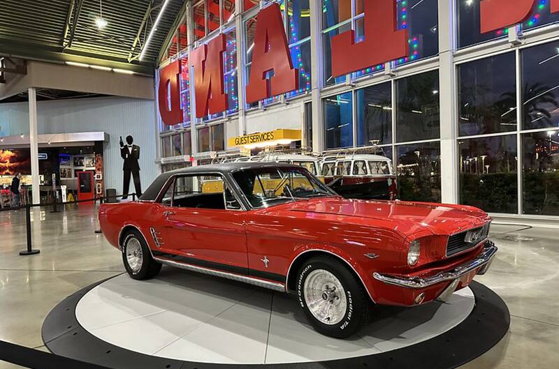 Red 1965 Mustang on rotating display in Museum